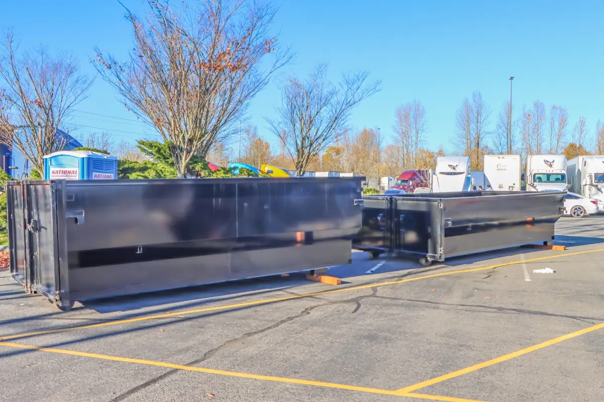 Professional dumpster rental service with roll-off container on residential driveway in South Riding